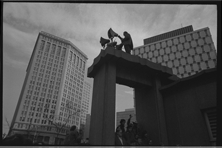 Photographer standing on arch at Kennedy Square