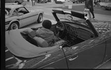 Teenage boy sitting in automobile, Detroit Auto Show