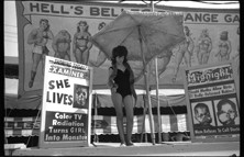 Woman with snake at sideshow, Michigan State Fair
