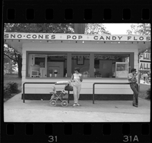 Woman with baby in stroller in front of concession stand, Bob-Lo Amusement Park