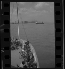 Passengers on Bob-Lo ferry watching freighter