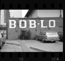 Station wagon parked under Bob-Lo sign