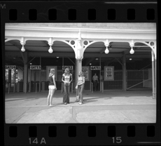 Teenage girls standing in front of entrance gates to Bob-Lo ferry
