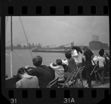 Passengers on Bob-Lo ferry watching freighter