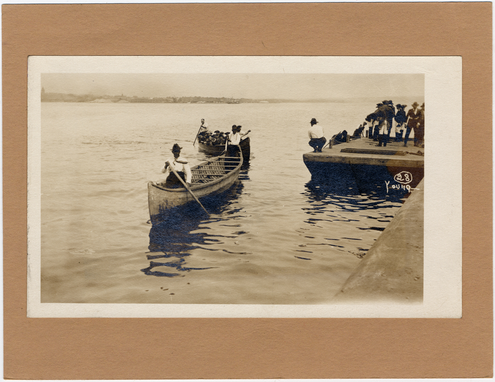 Canoes approaching dock in pageant