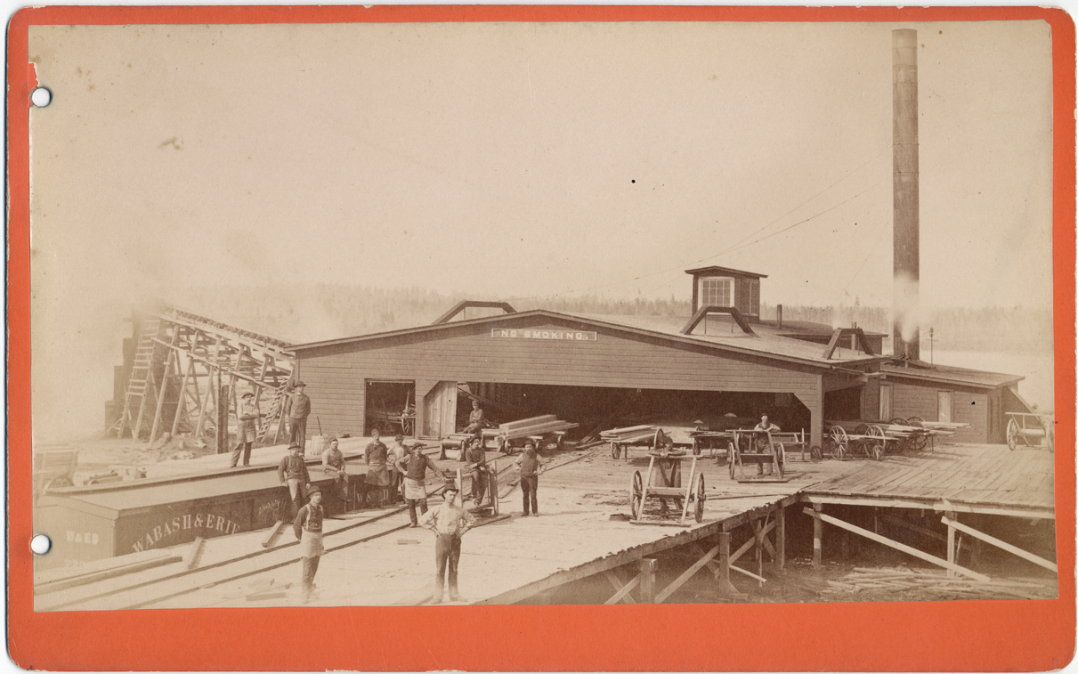 Sawmill workers in front of mill