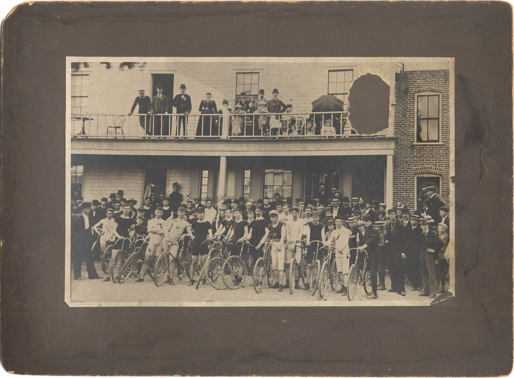 Group of cyclists by porch