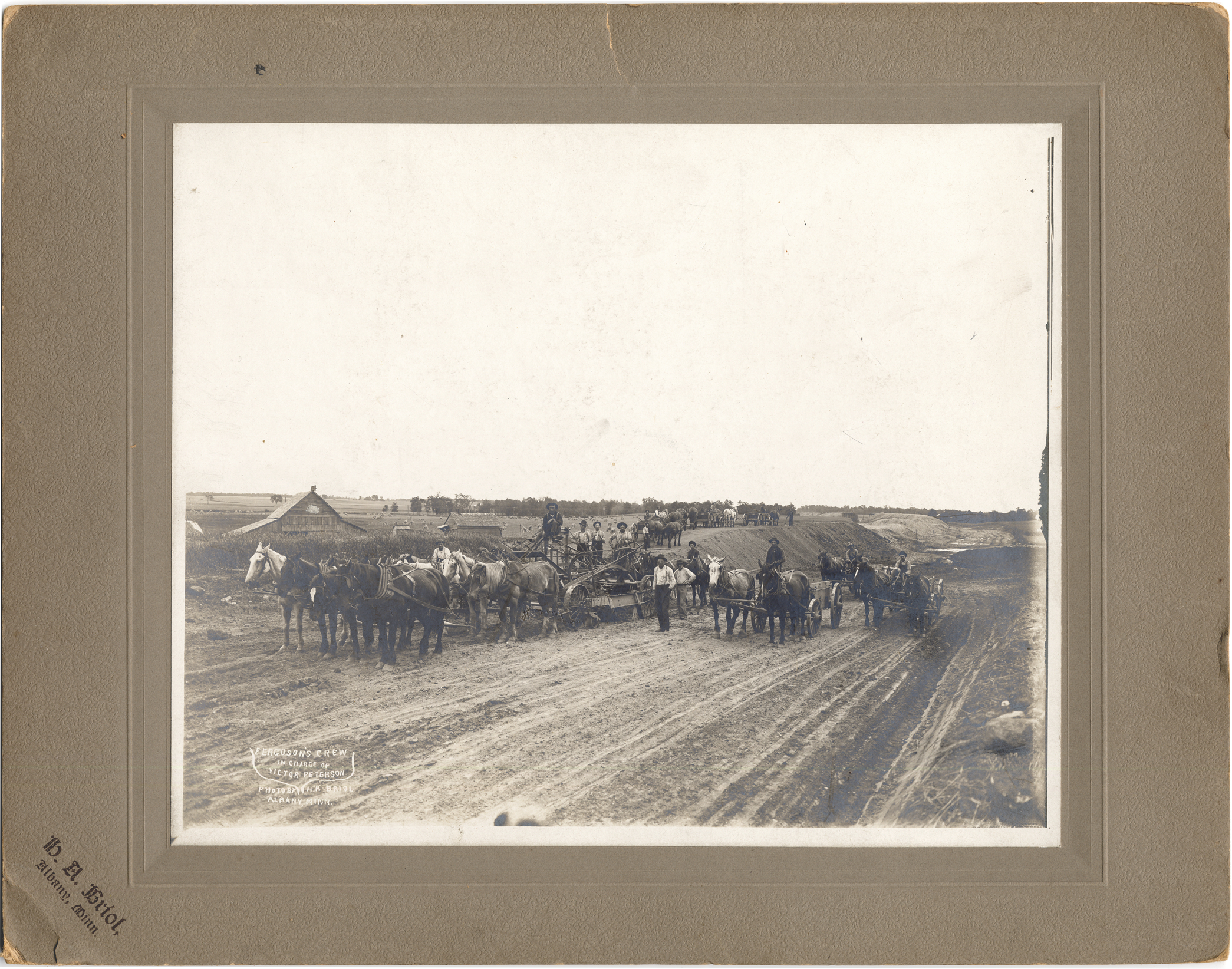 Men and wagons in farm country