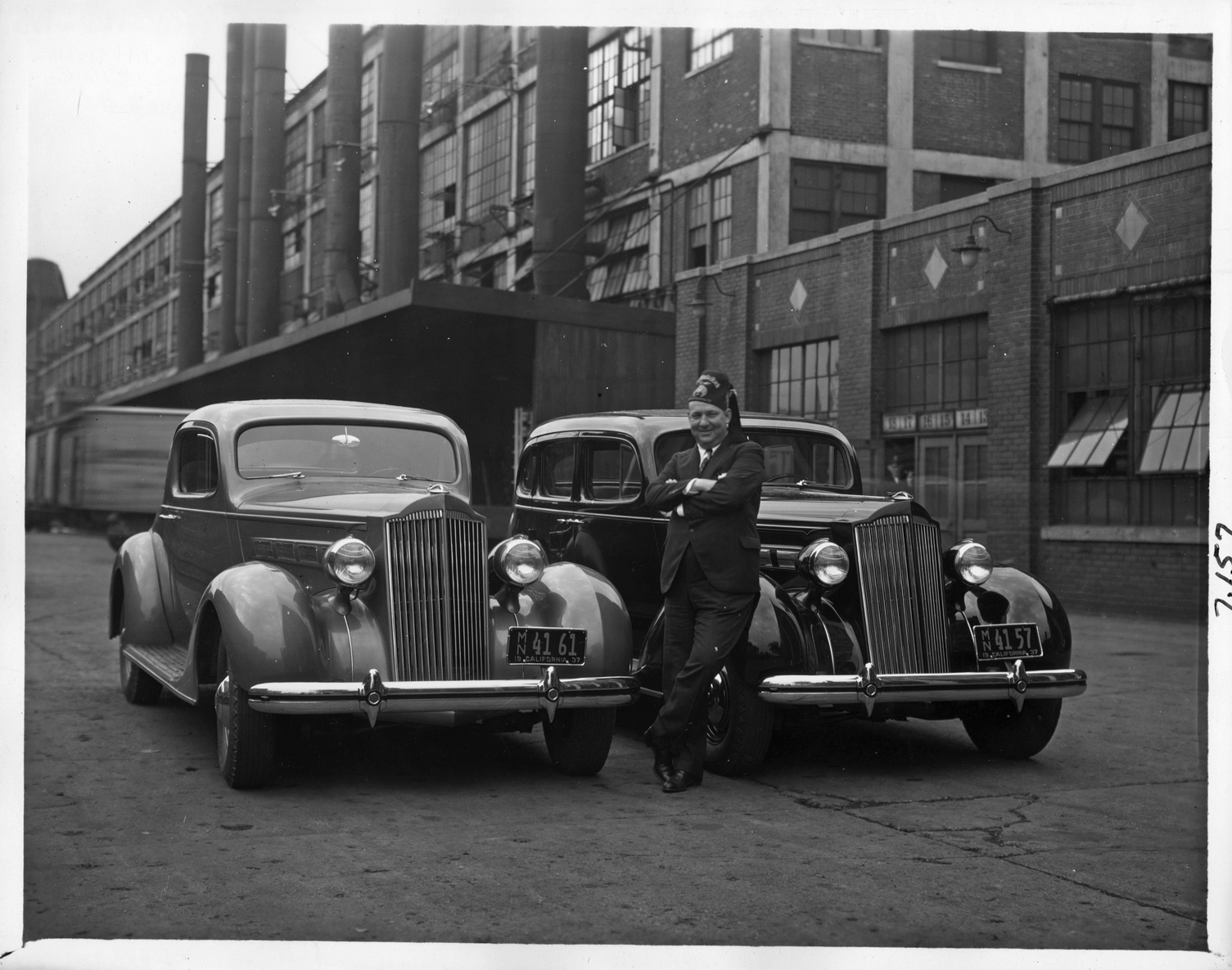 1937 Packard one twenties with owner at the Packard plant