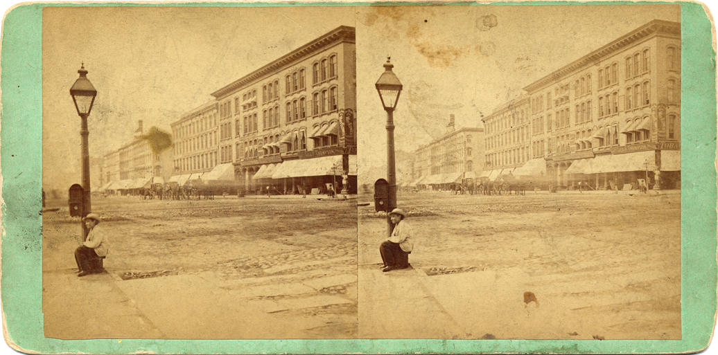 Boy beside street lamp on Woodward Avenue
