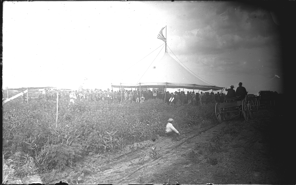 Group of people under canvas marquee
