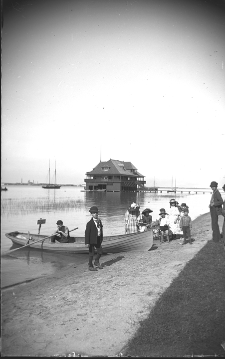 Group with boat on shore at the Detroit Yacht Club