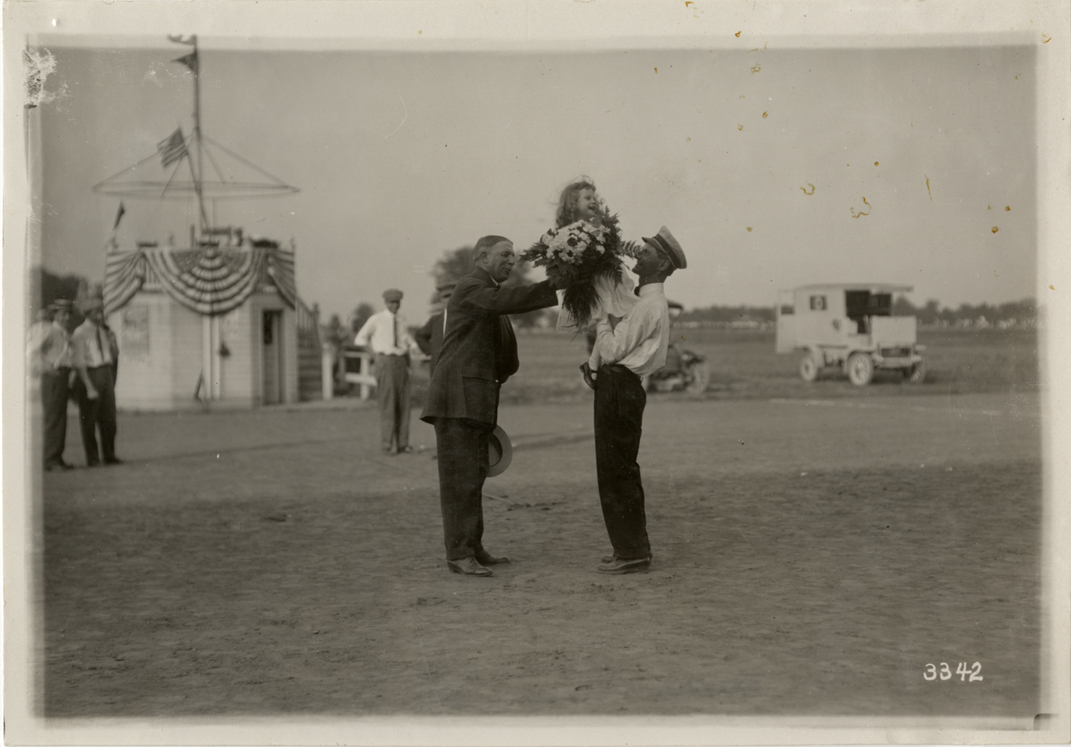 Girl holding bouquet at Detroit aviation meet