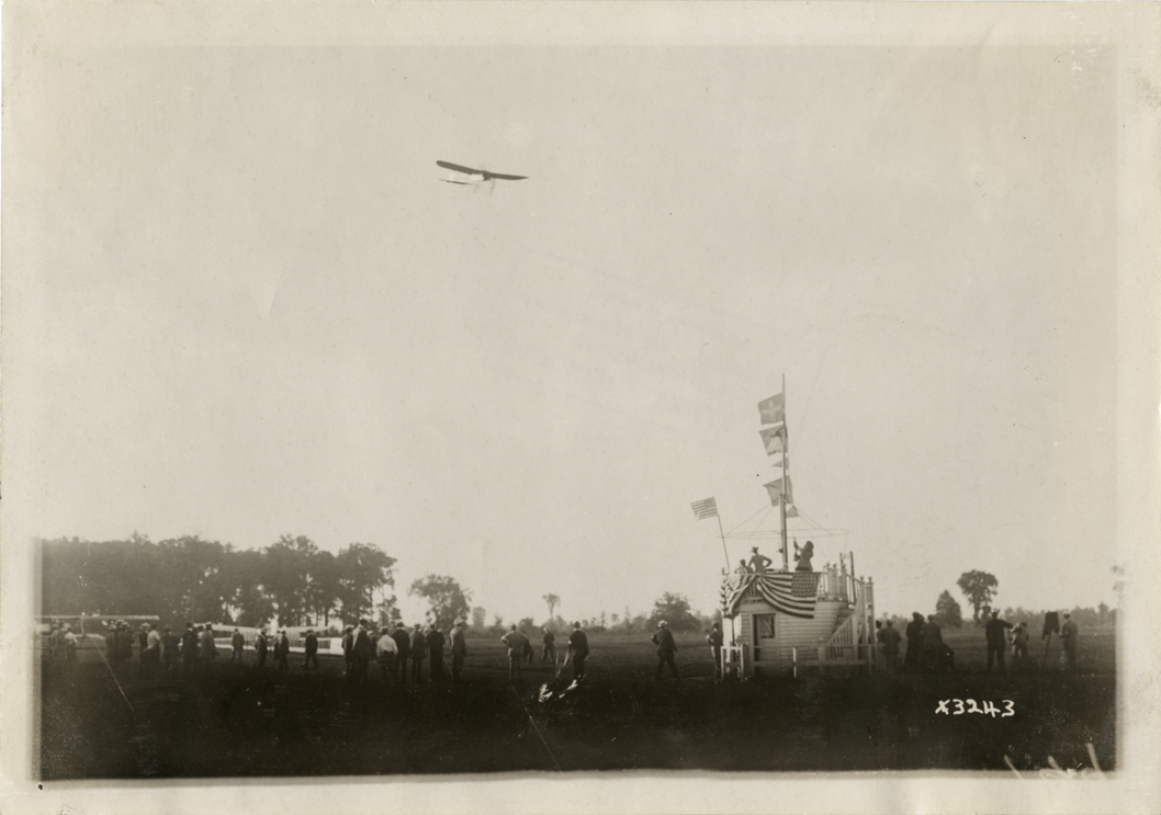 Airplane flying over reviewing stand at Detroit aviation meet