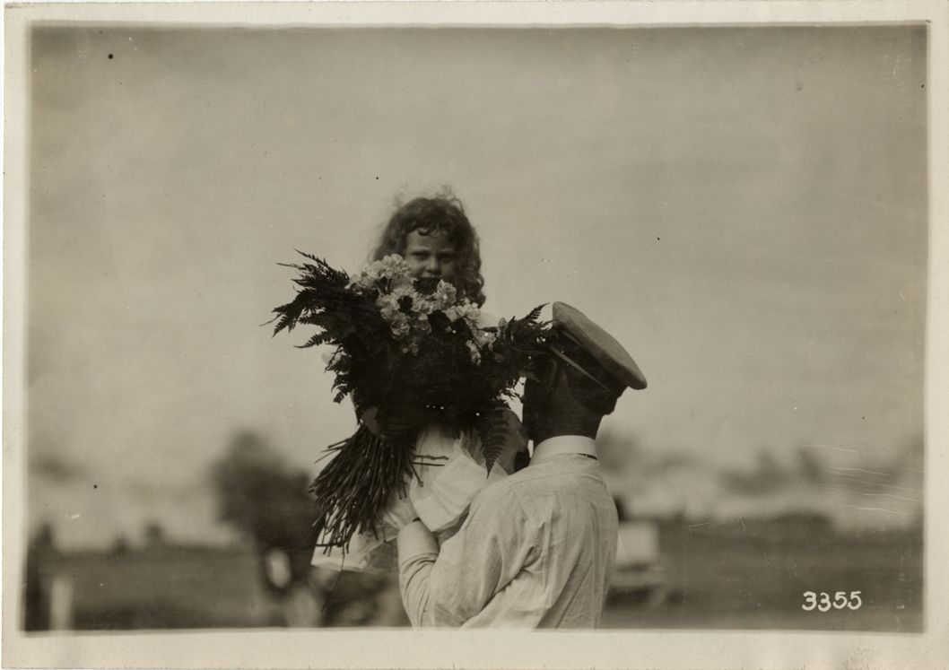 Girl holding bouquet at Detroit aviation meet