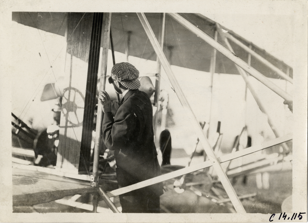 Arch Hoxsey with airplane at aviation exhibition, Michigan State Fairgrounds
