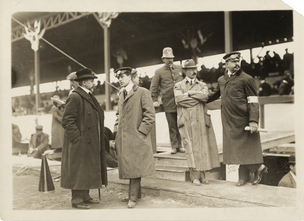 Men standing in front of grandstand