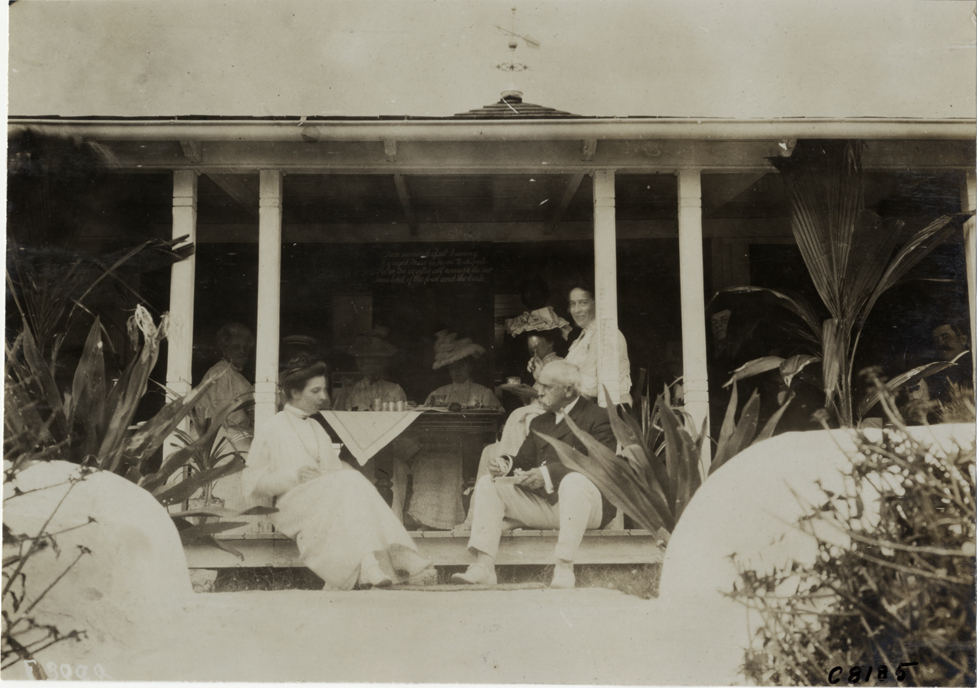 Men and women on veranda, Palm Beach boat carnival