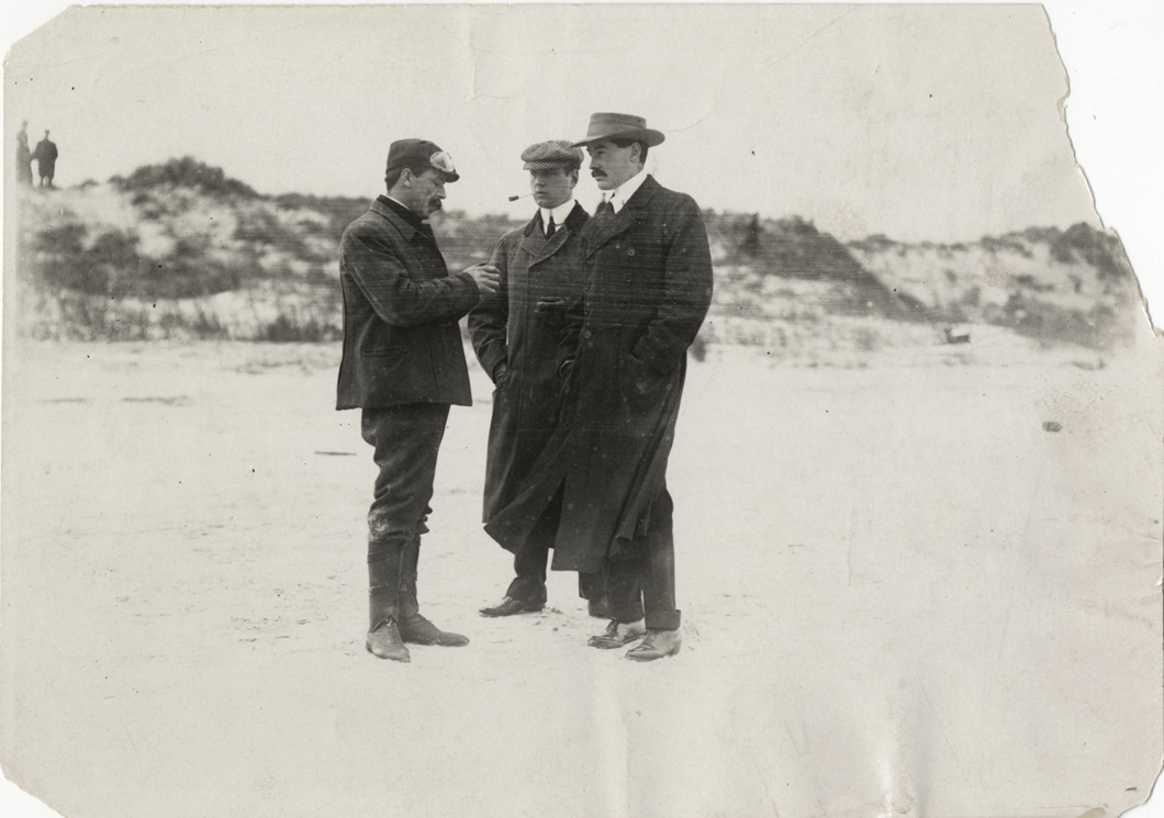 Alfred G. Vanderbilt speaking with two men