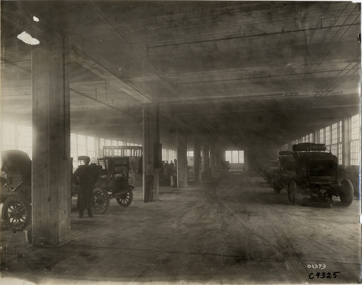 Workers with trucks at Rapid Motor Vehicle Company factory