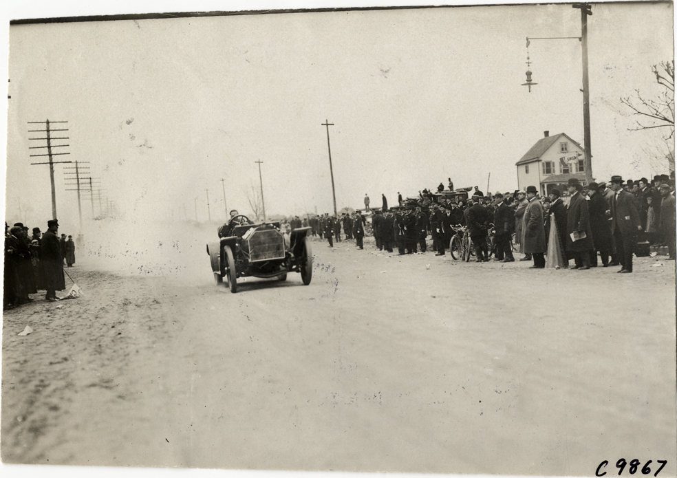 Driver in racecar, 1909 Fort George Hill Climb