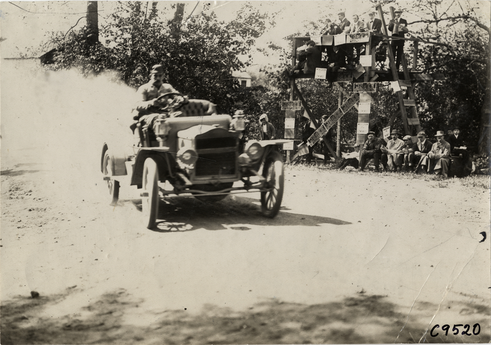 Driver in racecar, 1909 Bridgeport Hill Climb at Sport Hill, Connecticut