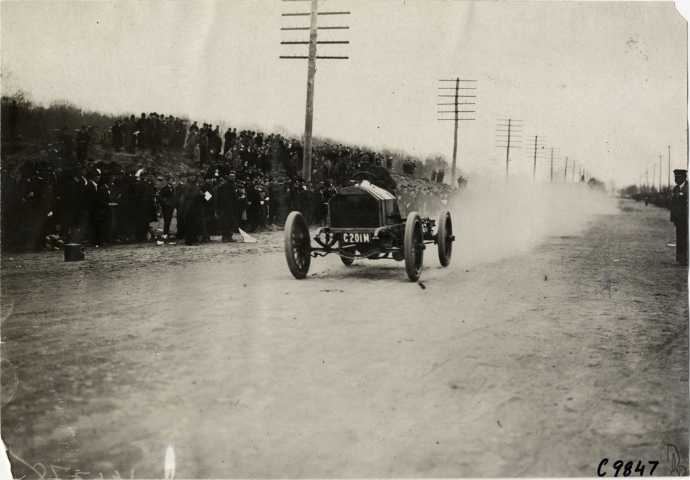 Driver in racecar, 1909 Fort George Hill Climb