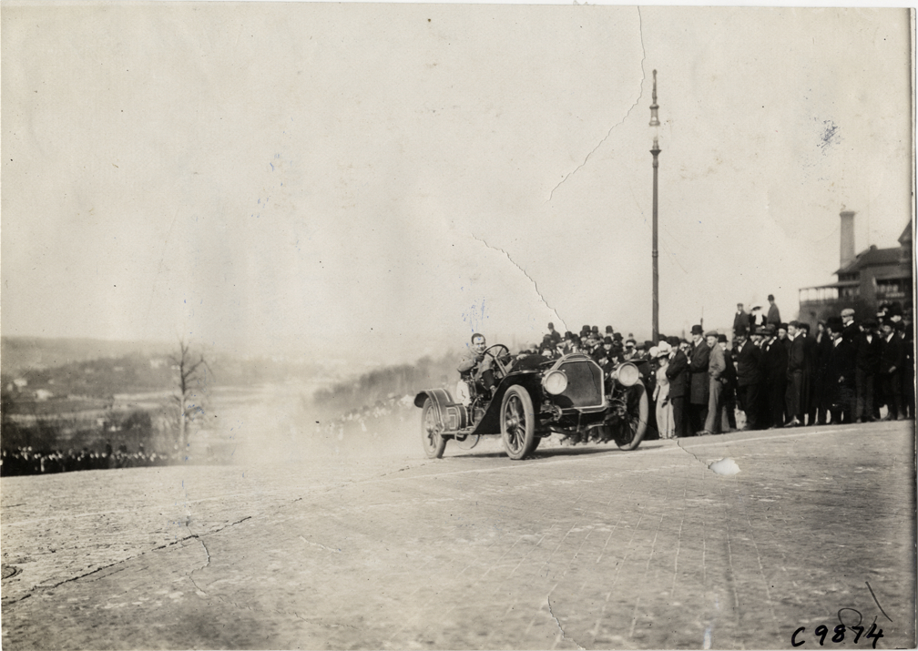 Driver in racecar, 1909 Fort George Hill Climb