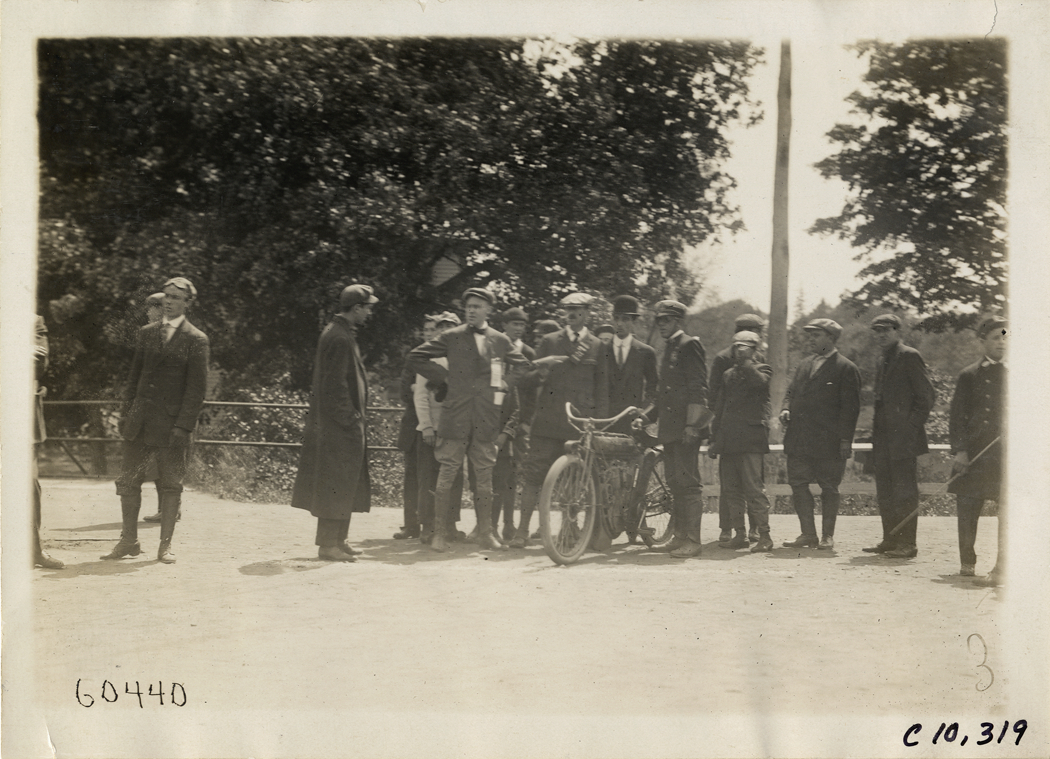 Group of men standing with motorcyclist, 1910 White Plains Hill Climb