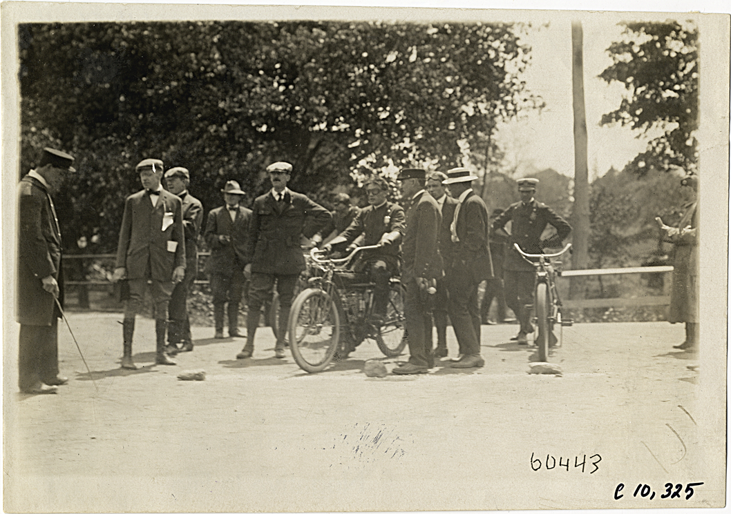 Group of men standing with motorcyclist, 1910 White Plains Hill Climb