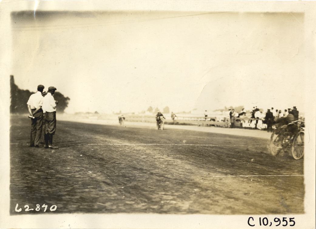Motorcyclist crossing finish line, 1910 Point Breeze motorcycle races