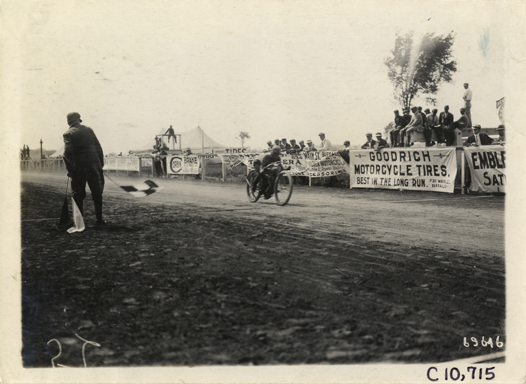 Frank Hart crossing finish line, 1911 Federation of American Motorcyclists races, Fort Erie, Ontario