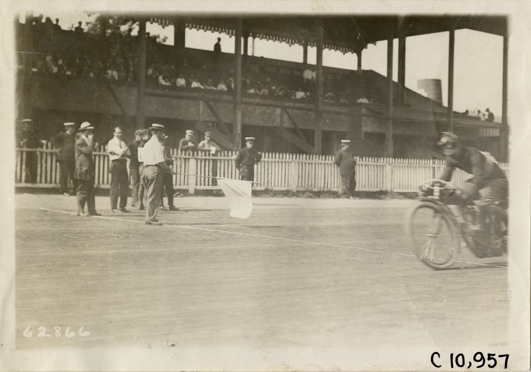 Motorcyclist crossing finish line, 1910 Point Breeze motorcycle races