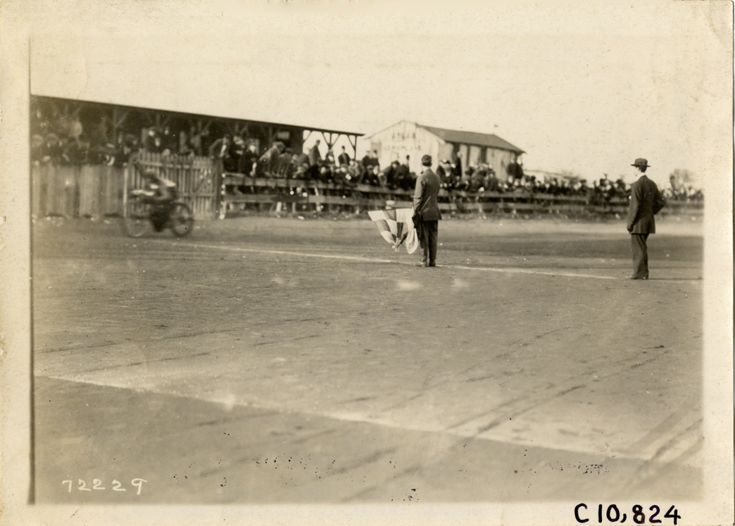 Motorcyclist crossing finish line, 1911 Guttenberg motorcycle races