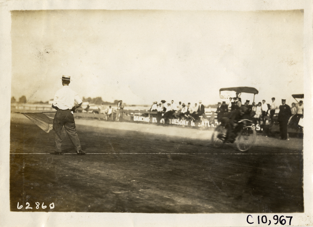 Motorcyclist crossing finish line, 1910 Point Breeze motorcycle races