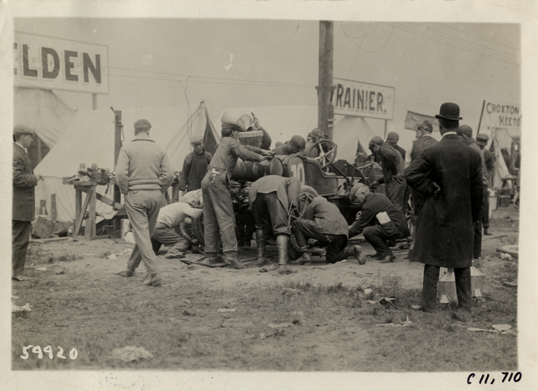 Men working on Selden racecar, 1909 Brighton Beach races