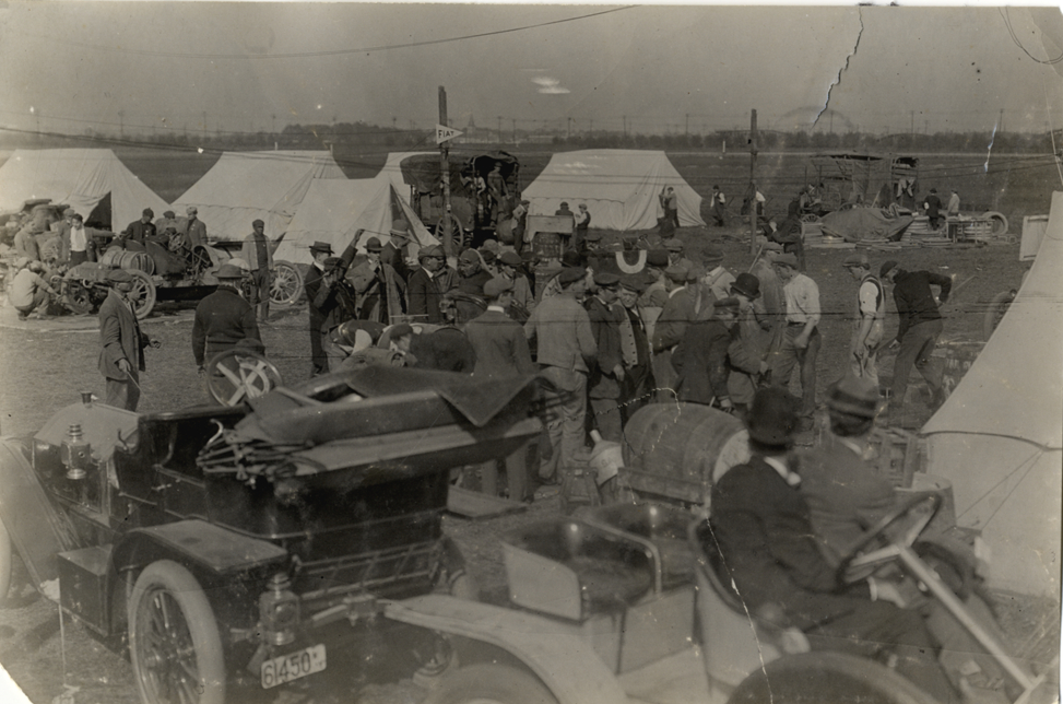 Men surrounding racecar, 1908 Brighton Beach races