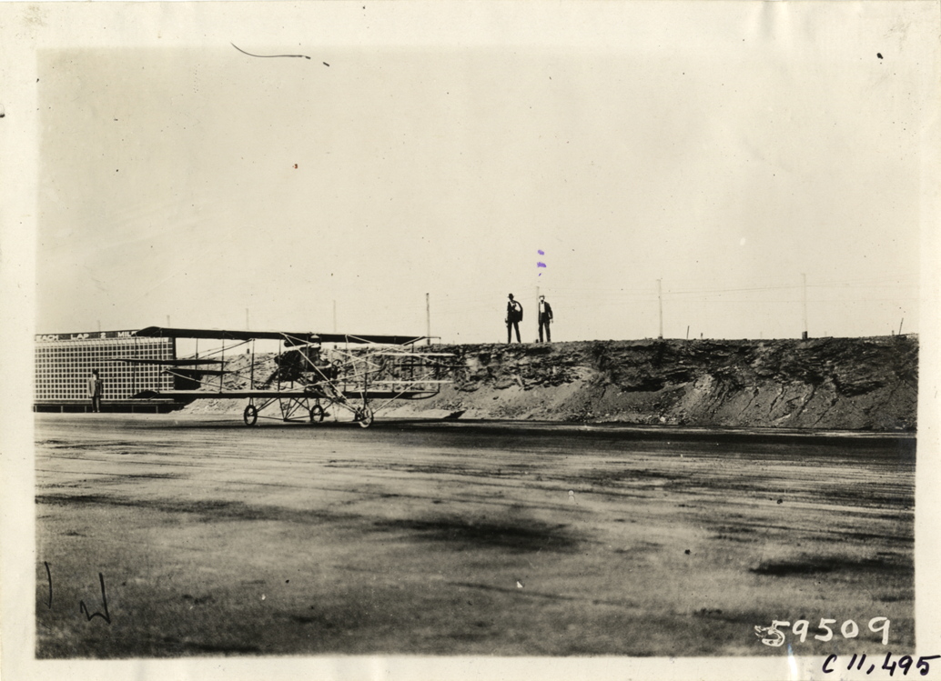 Biplane on racetrack, Atlanta Speedway