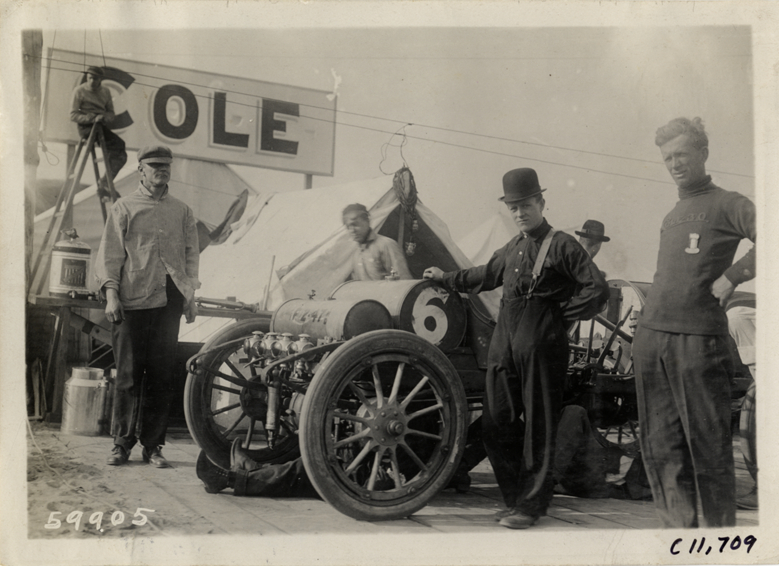 Men posing with Cole racecar, 1909 Brighton Beach races