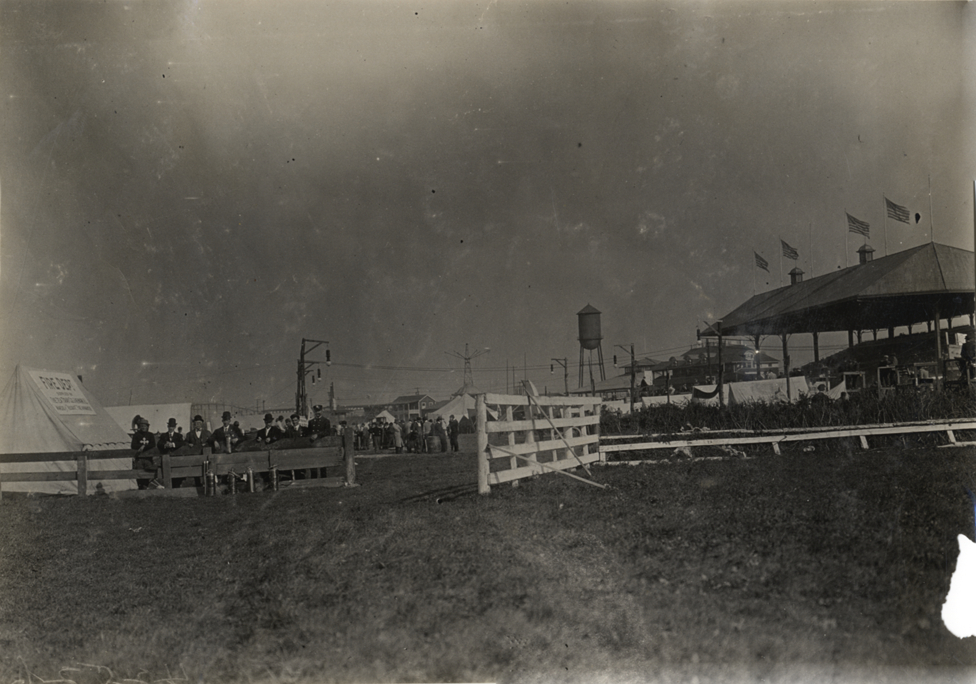 Men standing in front of Fire Dept. tent, 1908 Brighton Beach races