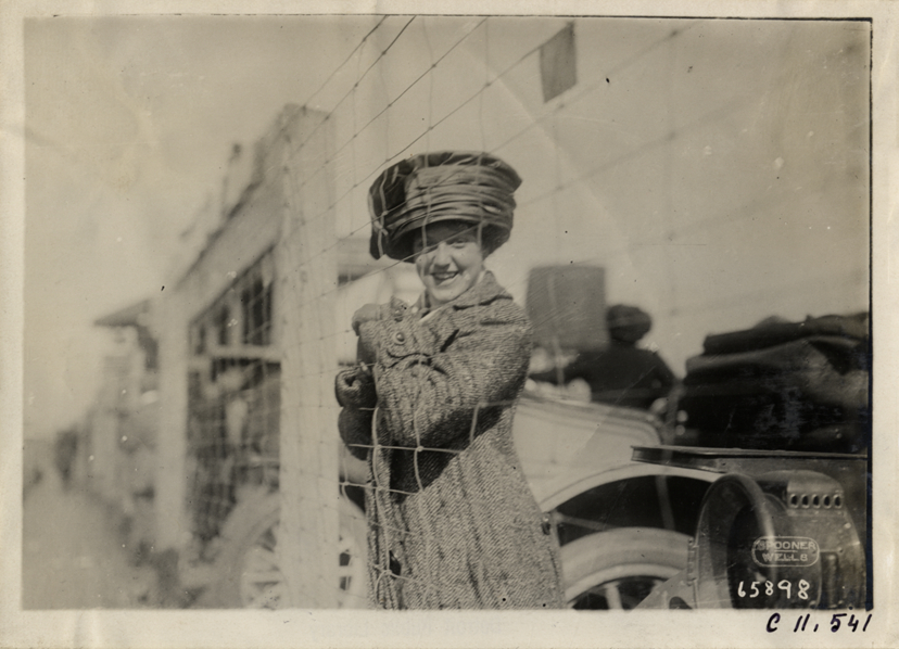 Woman standing behind fence, Atlanta Speedway
