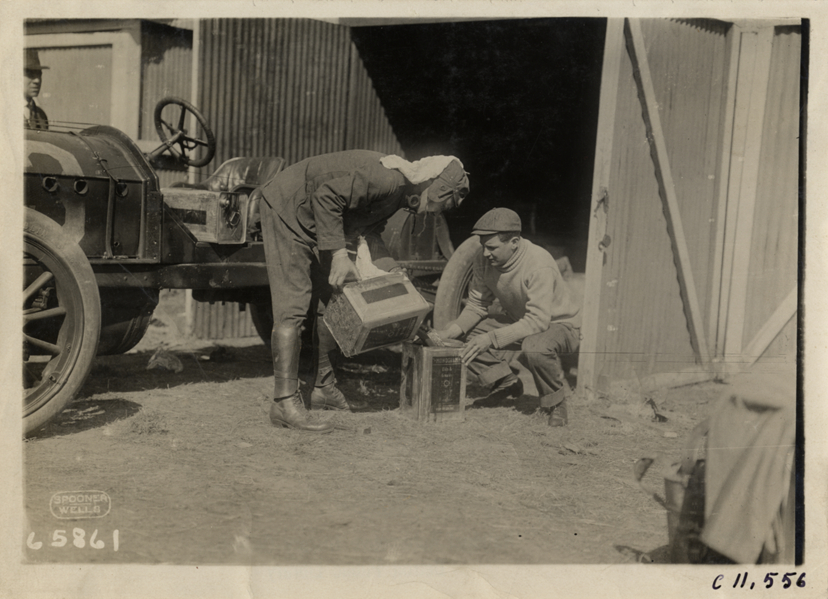 Men filling oil can, Atlanta Speedway