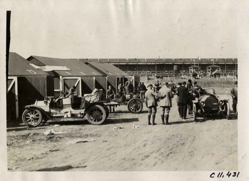 Men with racecars in front of garages, Atlanta Speedway