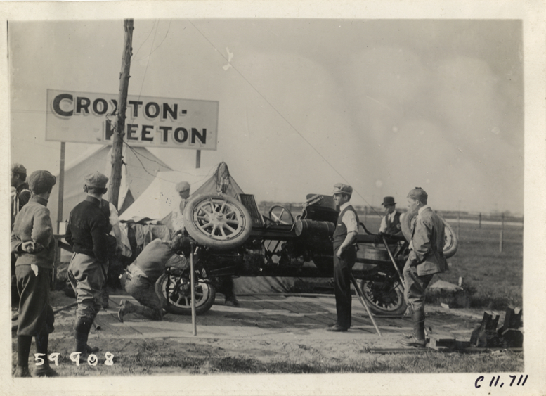 Men working on Croxton-Keeton racecar, 1909 Brighton Beach races