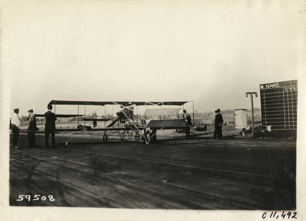 Biplane on racetrack, Atlanta Speedway