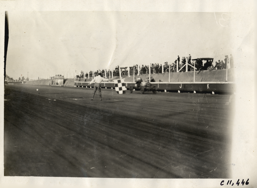 Disbrow in Rainier racecar crossing finish line, Atlanta Speedway