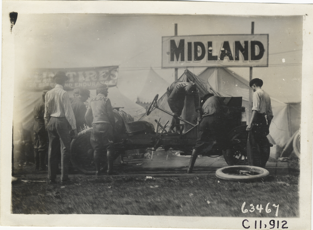 Men working on Midland racecar, 1910 Brighton Beach races