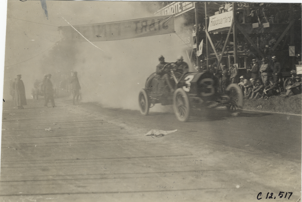 Racecar crossing finish line, 1909 Crown Point races
