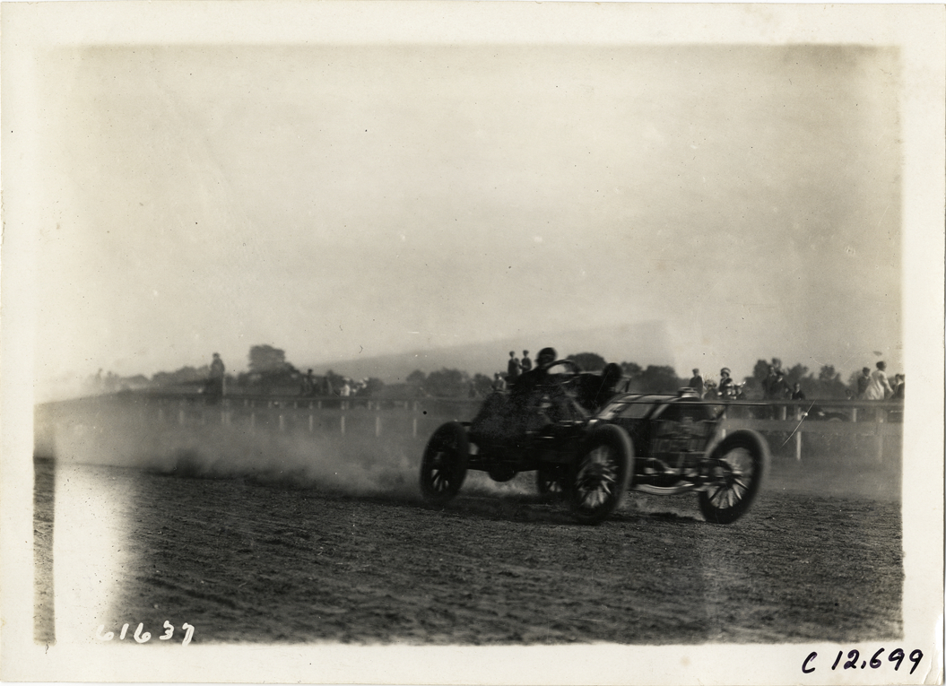 Driver in racecar, 1910 Empire City races