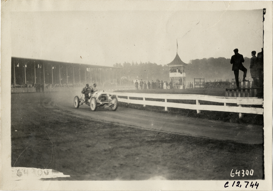 Driver and passenger in racecar, 1910 Empire City races